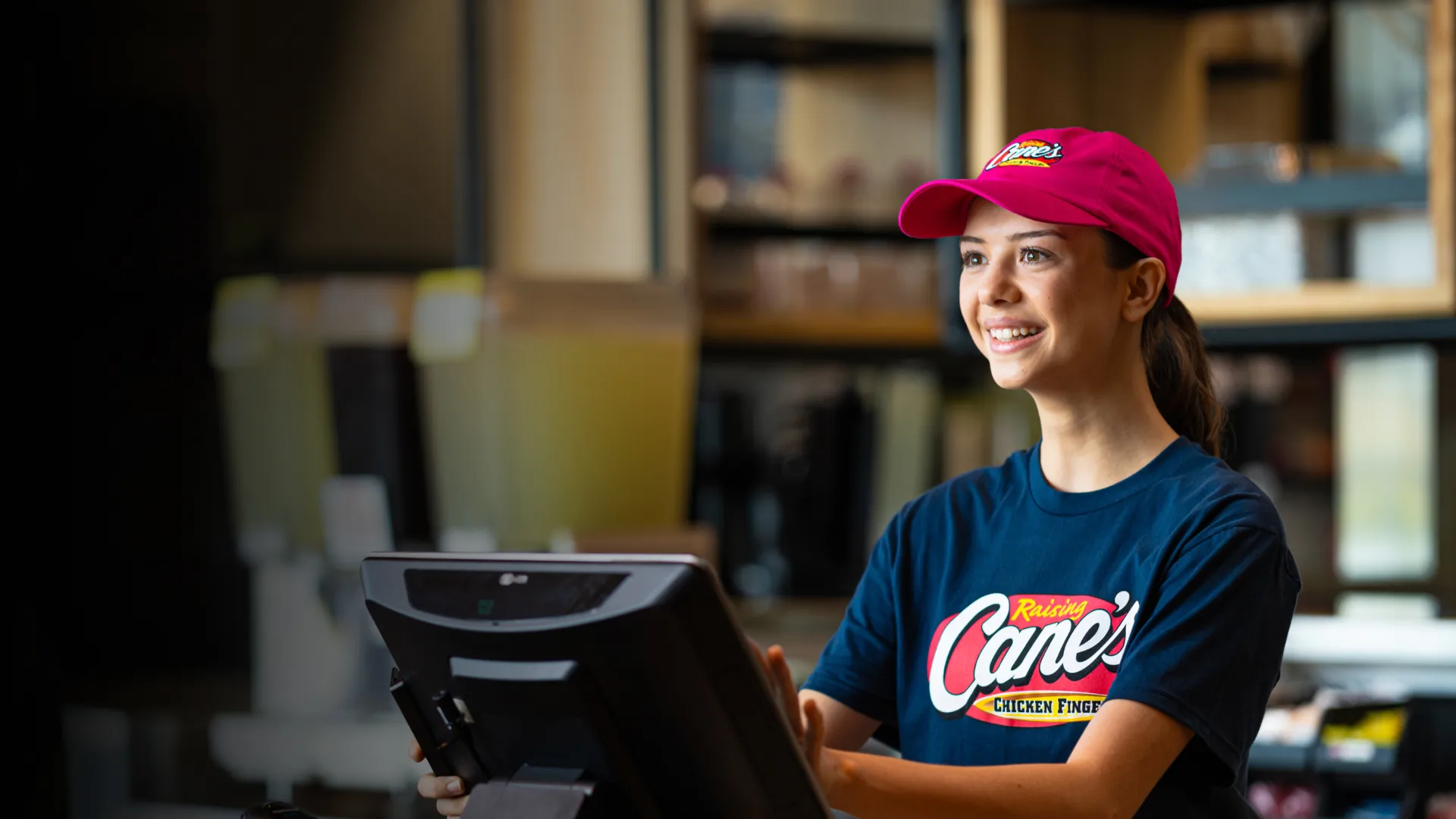 A female cashier smiling