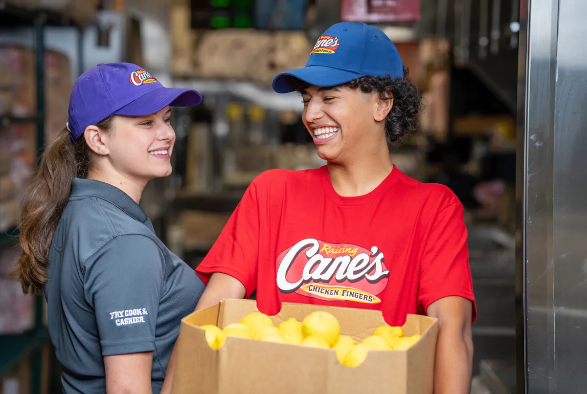 2 employees holding packages