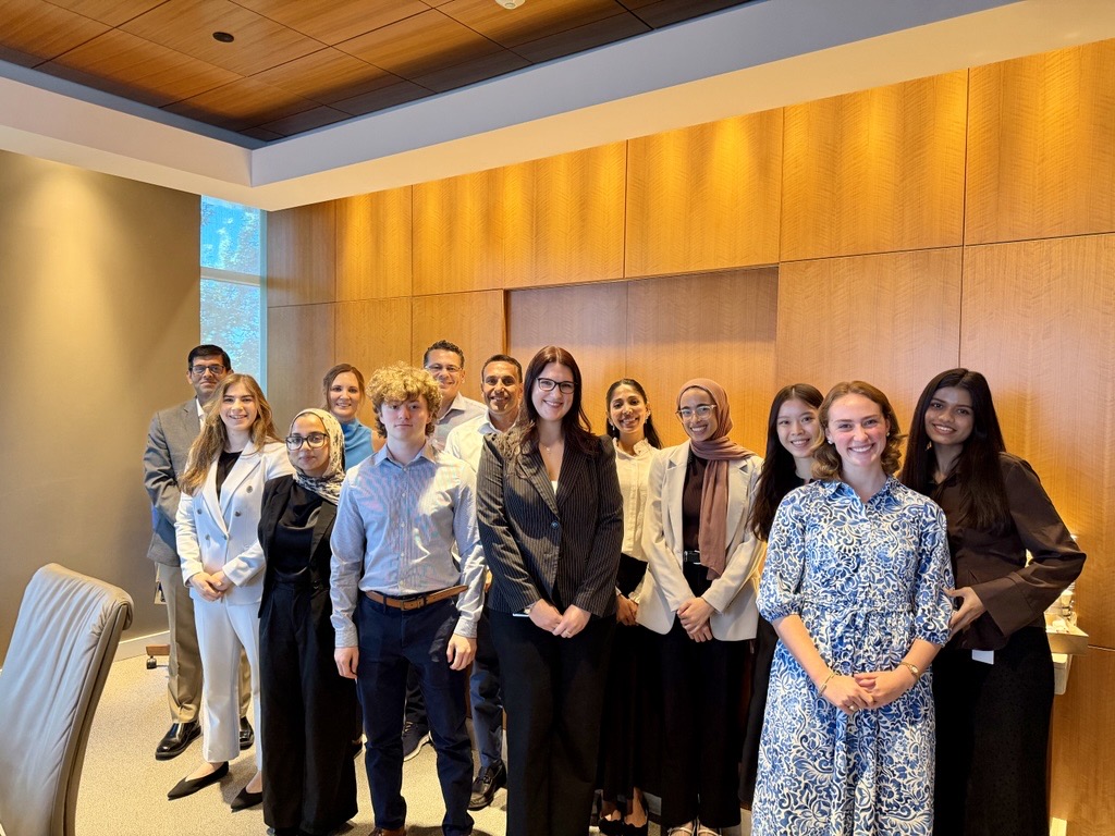 Upbound interns and leaders posing together in a conference room