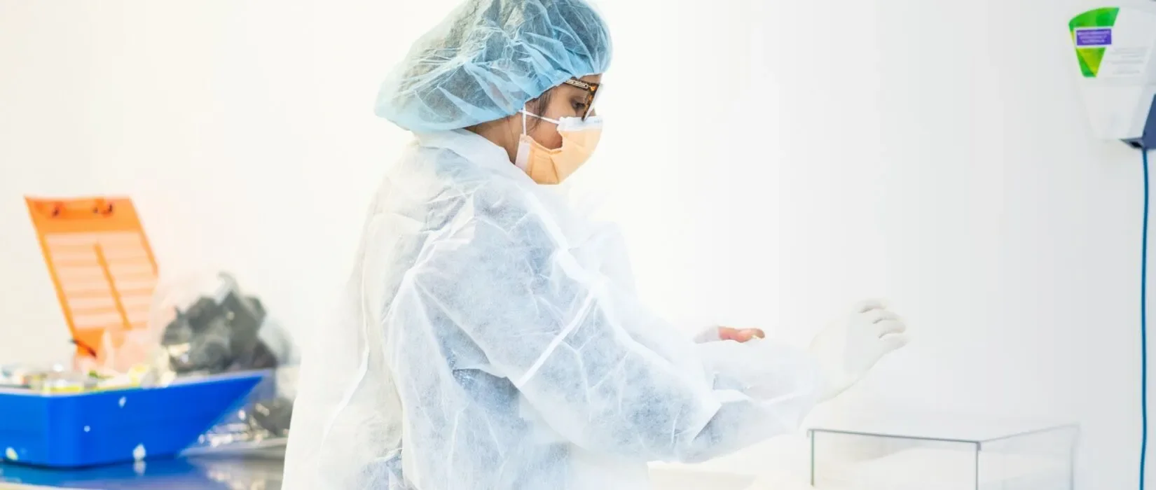 Medical professional in sterile environment working with equipment