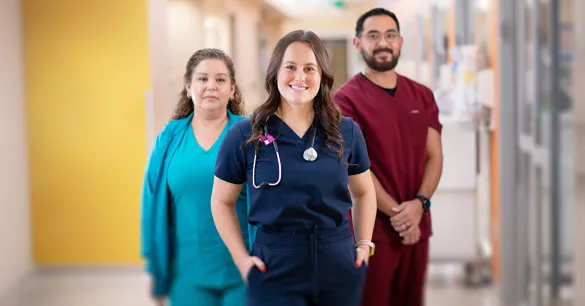 A group of doctors and nurses standing together in a clinic hallway