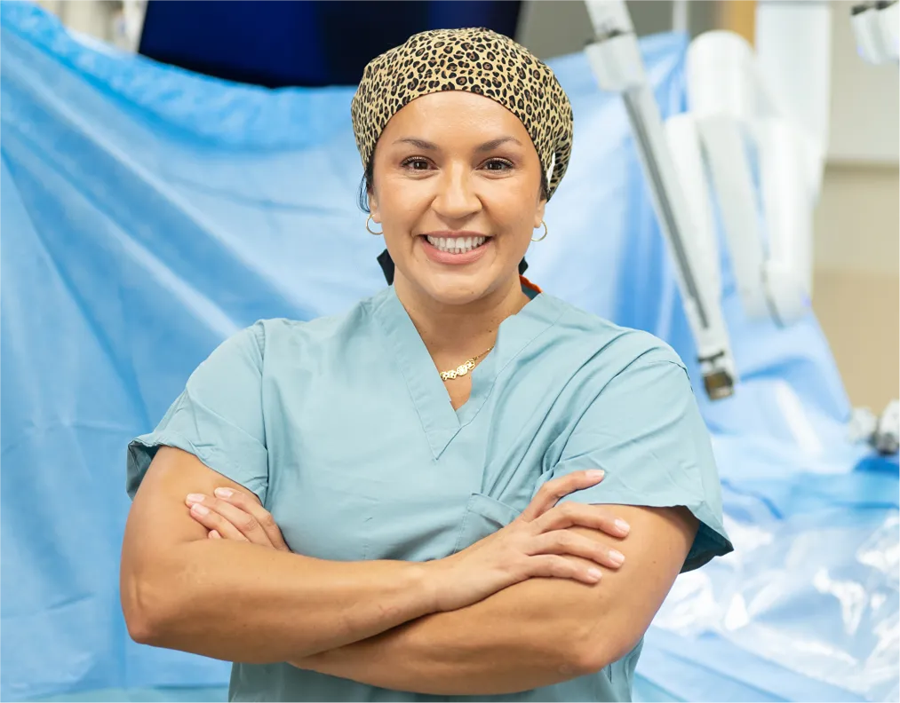 Onvida Health physician standing in a surgical suite next to advanced robotic equipment