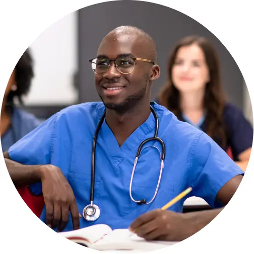 Nursing student taking notes in a classroom setting