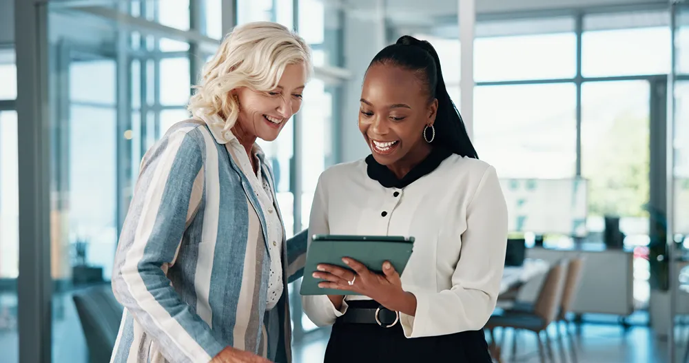 2 people looking at a laptop