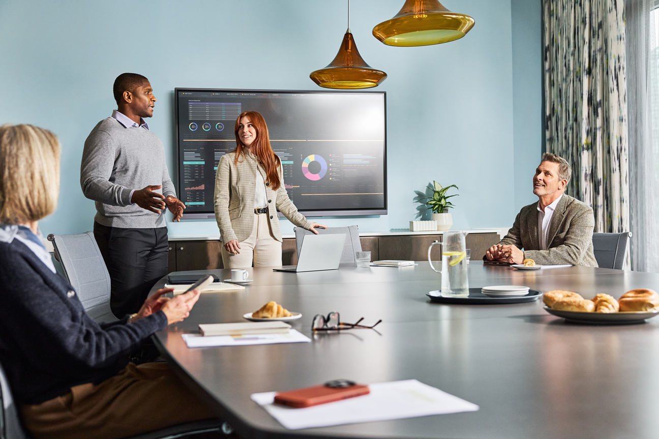 Employees presenting data during a meeting in a conference room