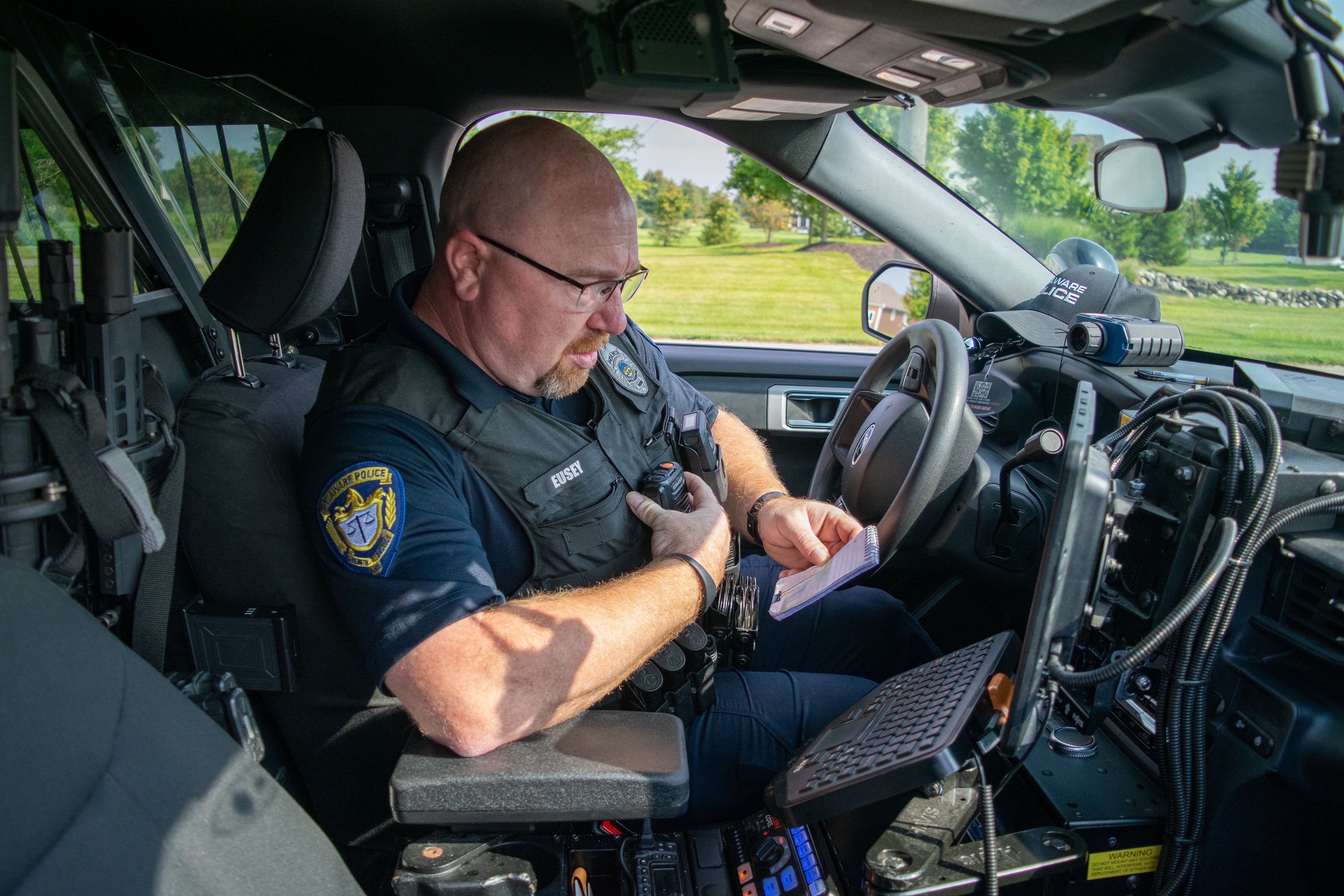 Male police officer sitting in police vehicle